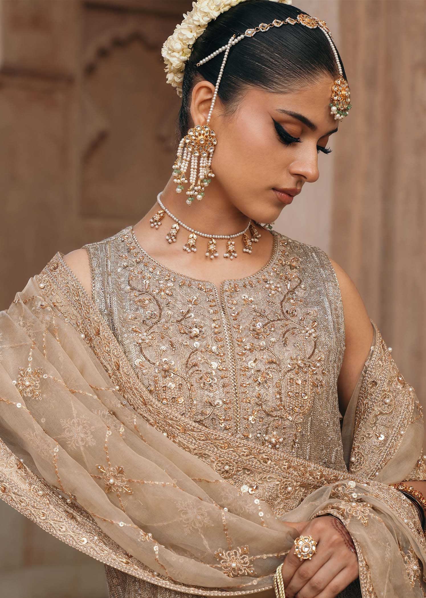 Model wearing Sitara by Kanwal Malik in champagne gold with intricate embellishments – stunning Pakistani luxury pret outfit in UK.