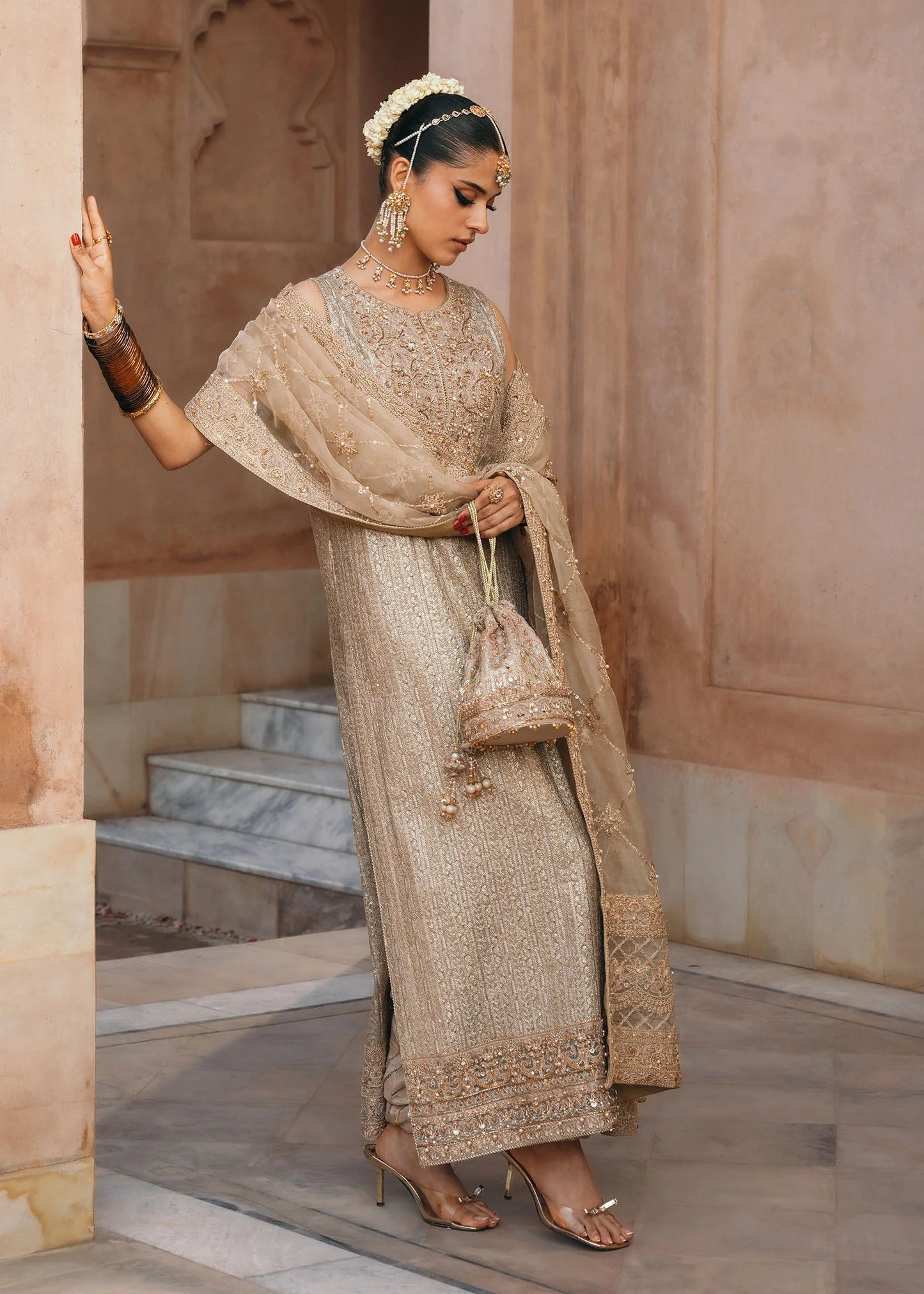 Model wearing Sitara by Kanwal Malik in champagne gold with intricate embellishments – stunning Pakistani luxury pret outfit in UK.
