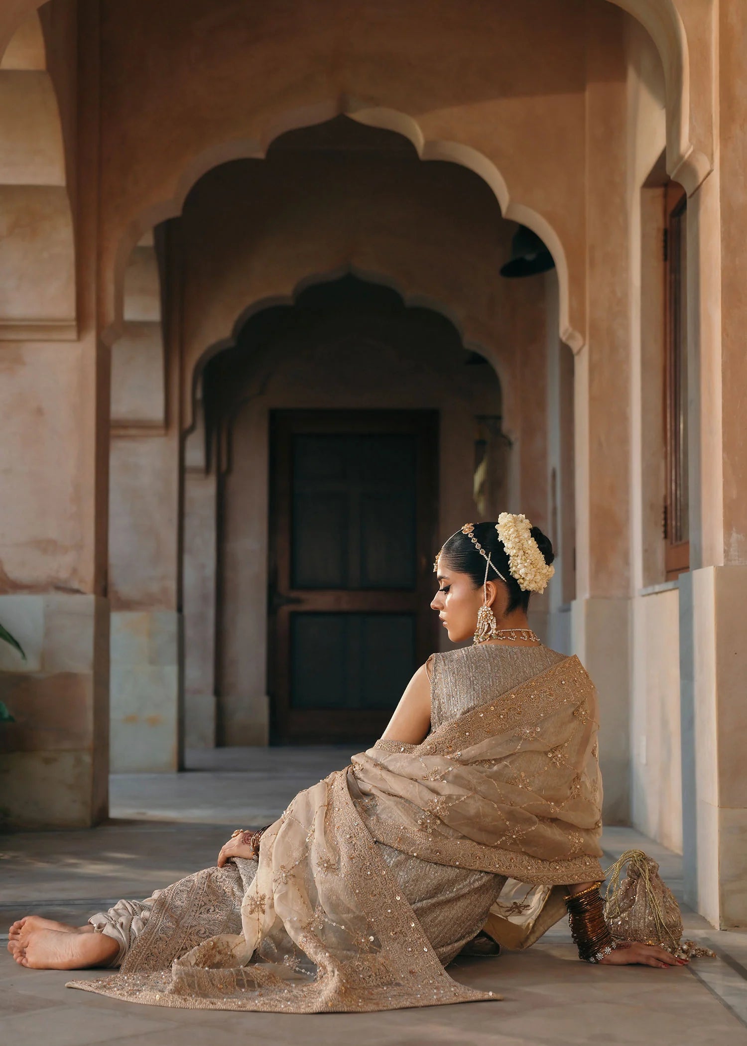 Model wearing Sitara by Kanwal Malik in champagne gold with intricate embellishments – stunning Pakistani luxury pret outfit in UK.