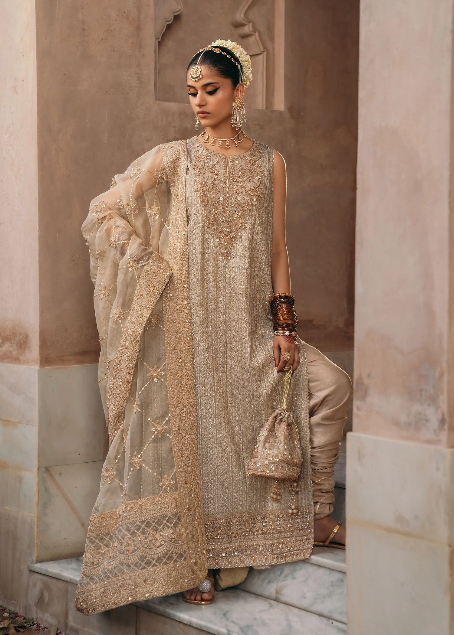 Model wearing Sitara by Kanwal Malik in champagne gold with intricate embellishments – stunning Pakistani luxury pret outfit in UK.