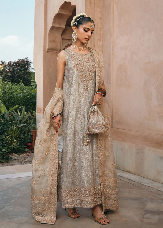 Model wearing Sitara by Kanwal Malik in champagne gold with intricate embellishments – stunning Pakistani luxury pret outfit in UK.