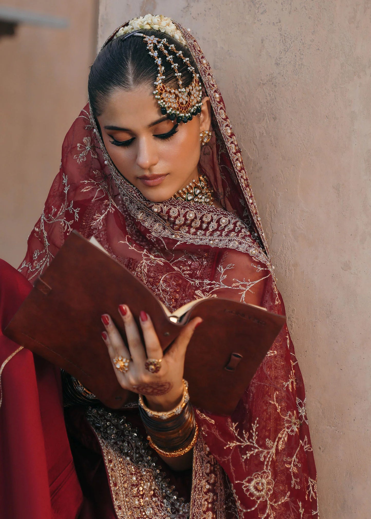 Model wearing Mehek by Kanwal Malik in deep maroon with gold embroidery and net dupatta – elegant Pakistani luxury pret outfit in UK.