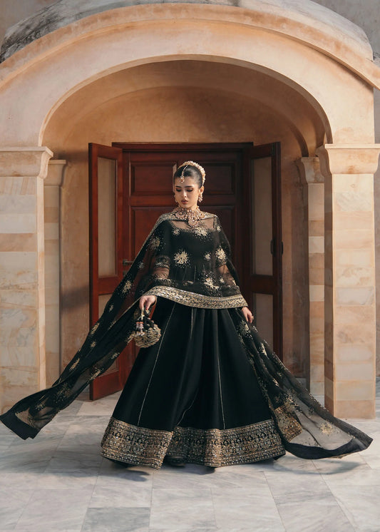Model wearing Kajal by Kanwal Malik in black with gold embroidery and sheer dupatta – striking Pakistani luxury pret outfit in UK.