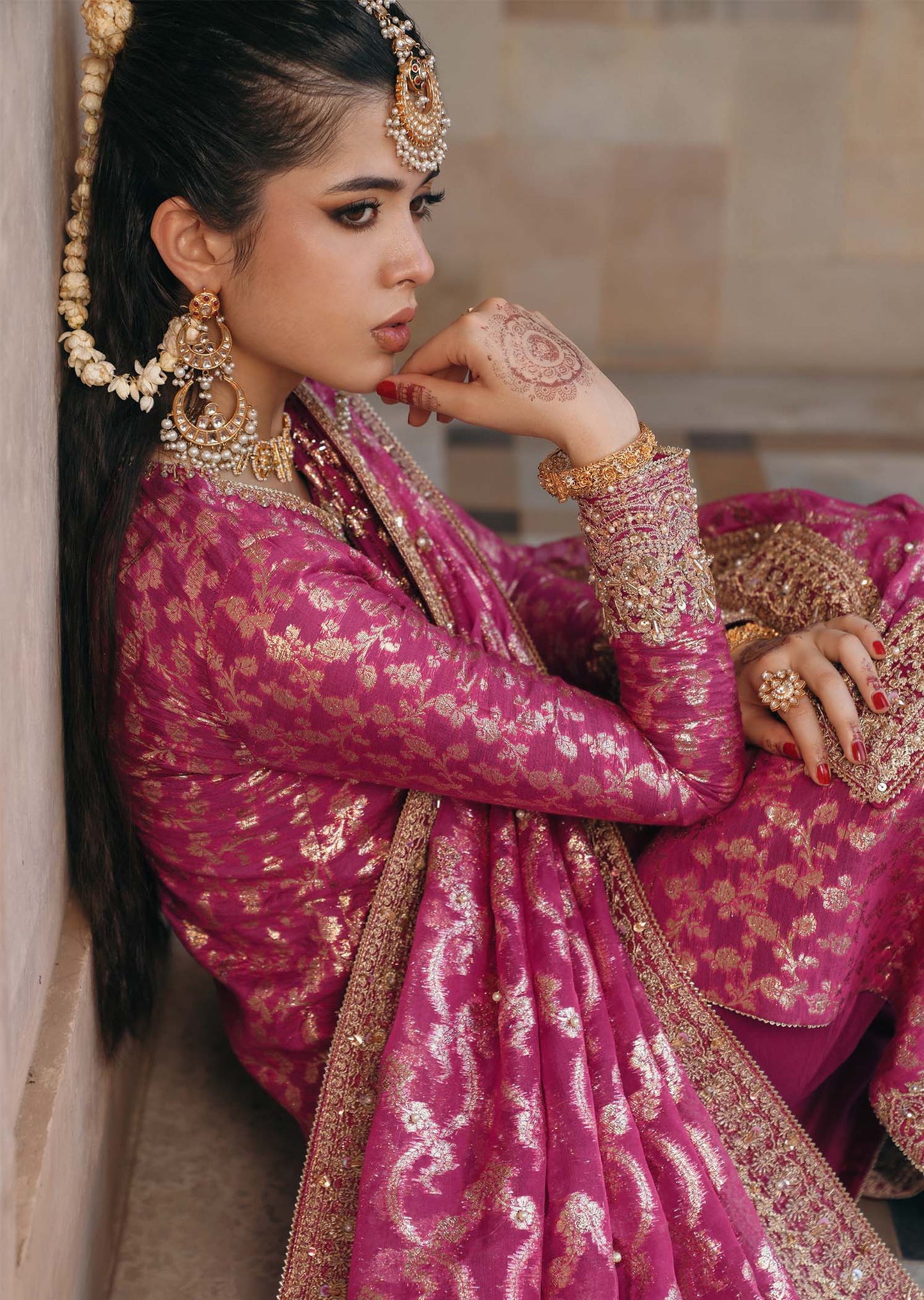 Model wearing Rano by Kanwal Malik in hot pink with intricate gold detailing – vibrant Pakistani luxury pret outfit in UK.
