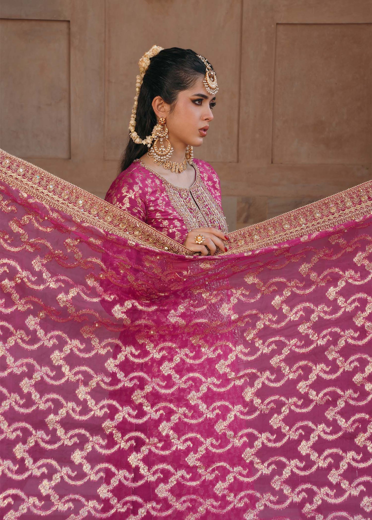Model wearing Rano by Kanwal Malik in hot pink with intricate gold detailing – vibrant Pakistani luxury pret outfit in UK.