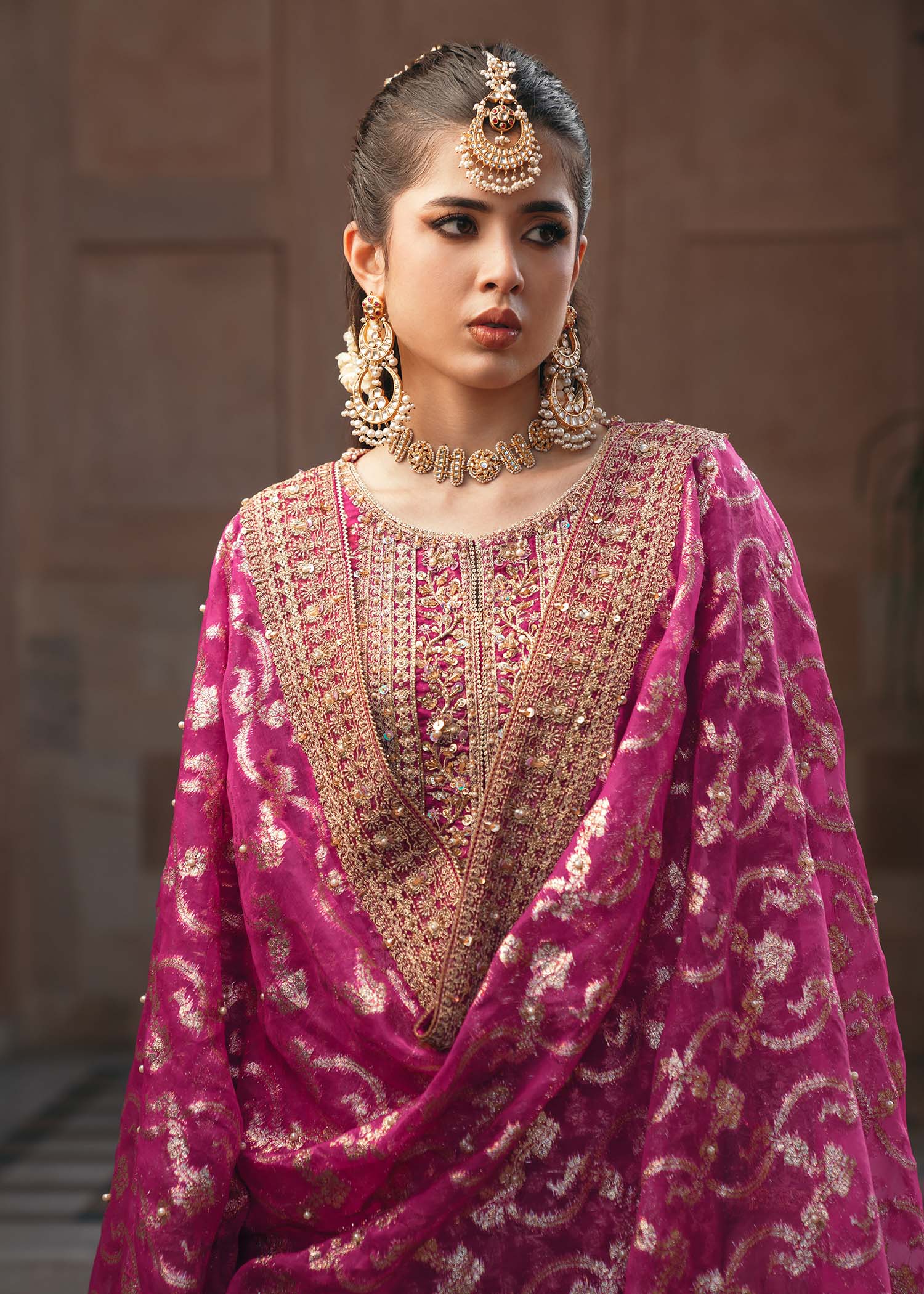 Model wearing Rano by Kanwal Malik in hot pink with intricate gold detailing – vibrant Pakistani luxury pret outfit in UK.