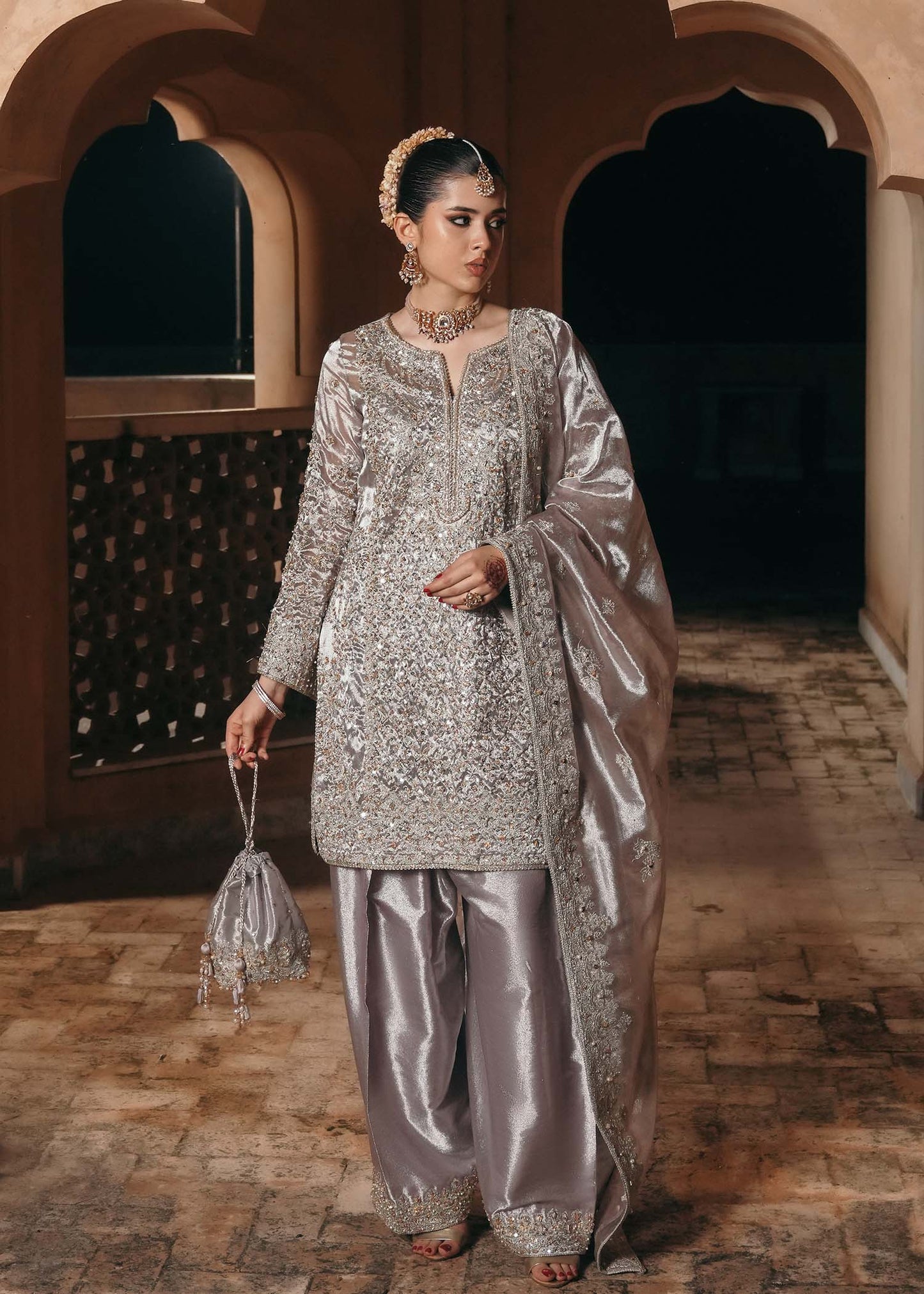 Model wearing Gulnaar by Kanwal Malik in metallic silver with intricate embellishments – elegant Pakistani luxury pret outfit in UK.