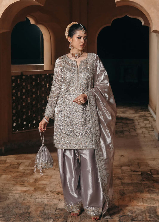 Model wearing Gulnaar by Kanwal Malik in metallic silver with intricate embellishments – elegant Pakistani luxury pret outfit in UK.