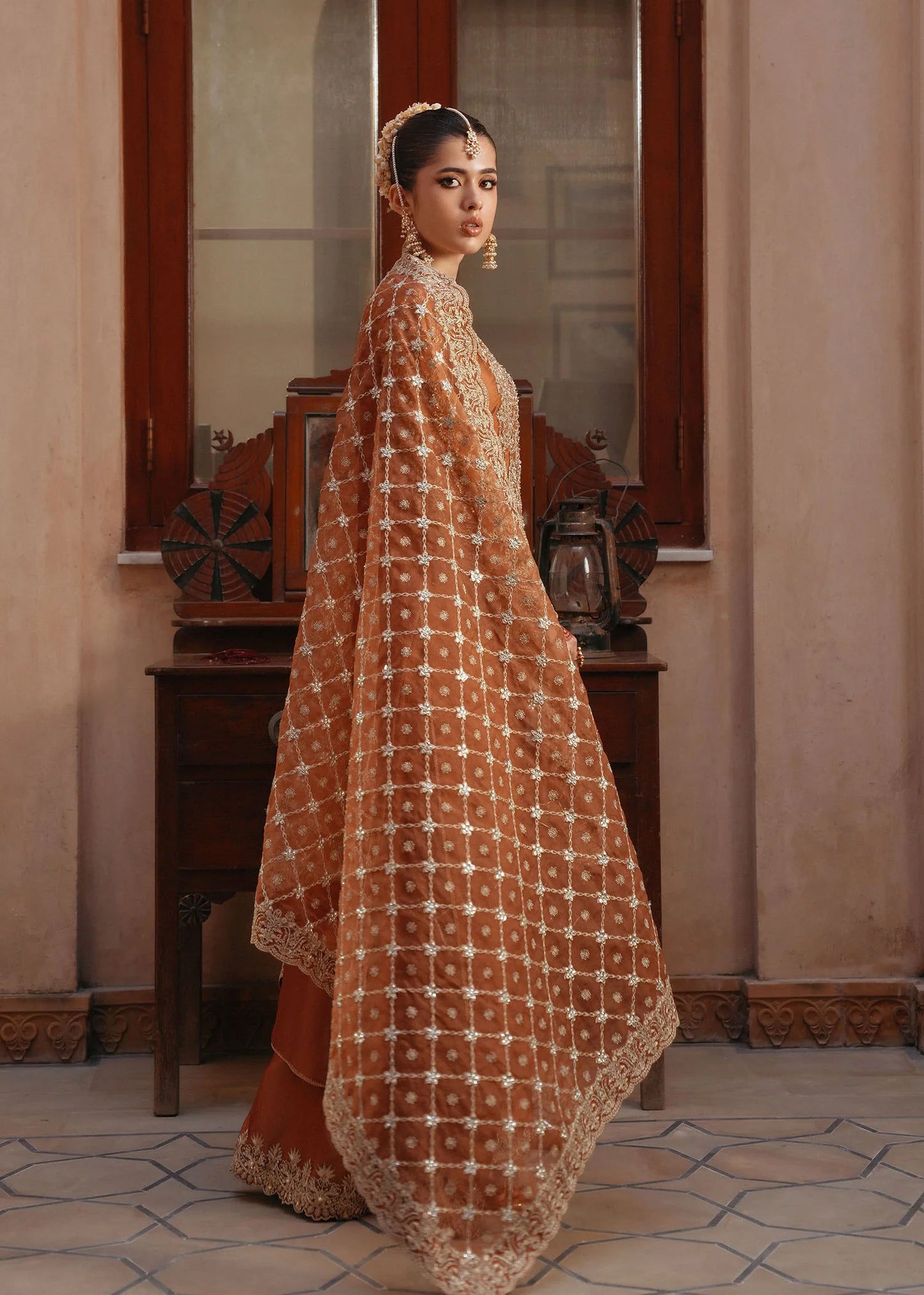 Model wearing Zulekha by Kanwal Malik in rust orange with gold embroidery – timeless Pakistani luxury pret available online in UK.