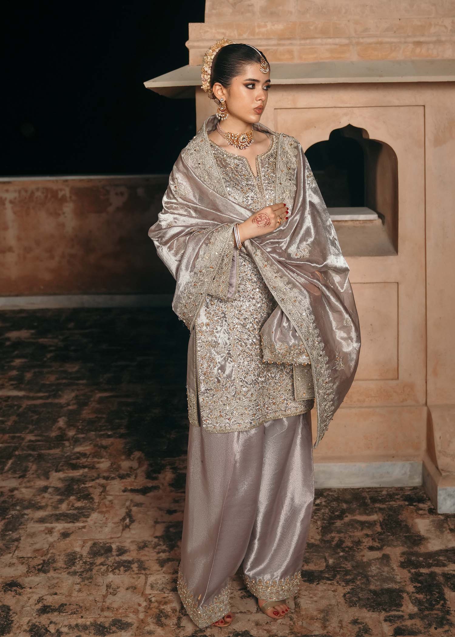 Model wearing Gulnaar by Kanwal Malik in metallic silver with intricate embellishments – elegant Pakistani luxury pret outfit in UK.