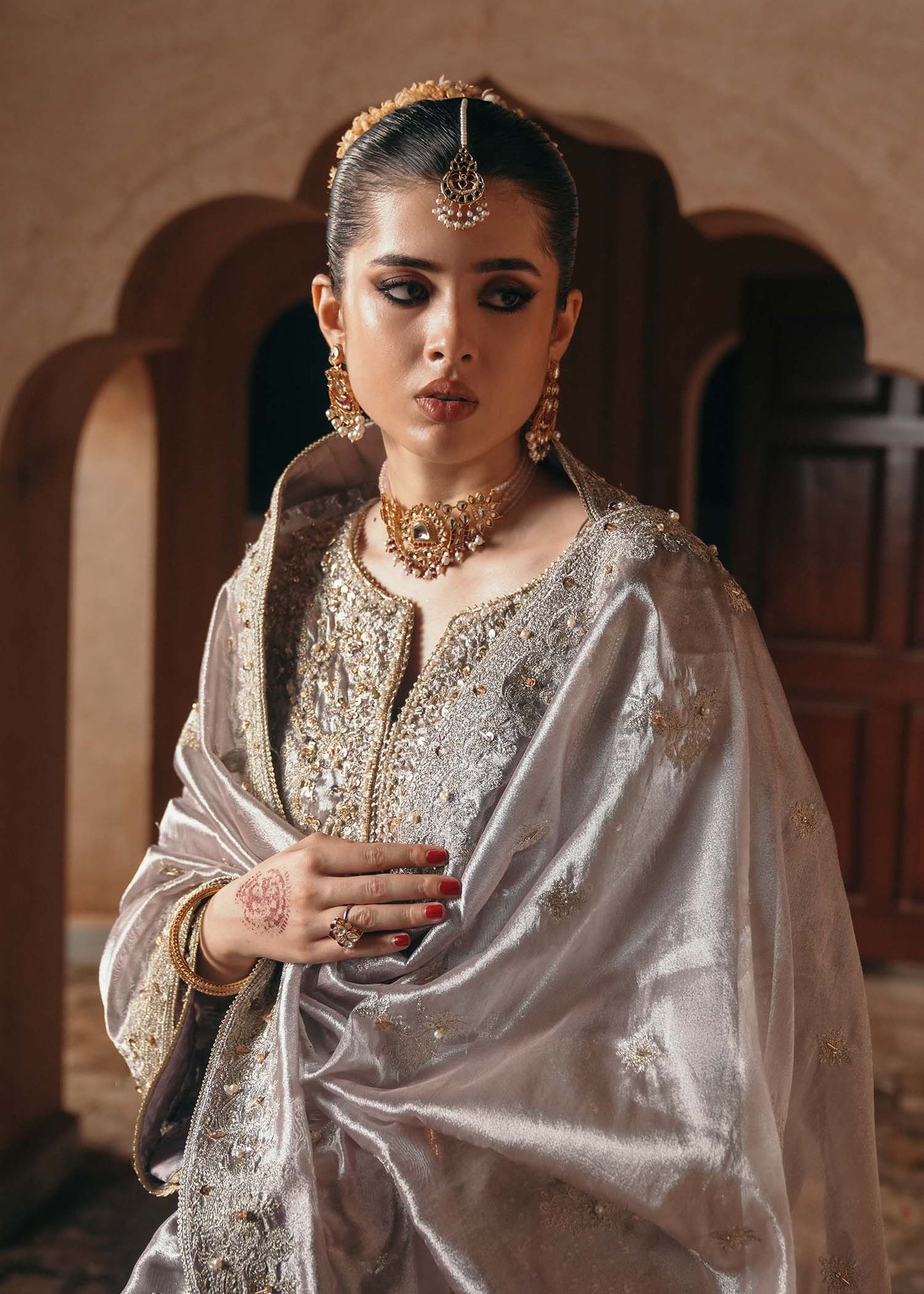 Model wearing Gulnaar by Kanwal Malik in metallic silver with intricate embellishments – elegant Pakistani luxury pret outfit in UK.
