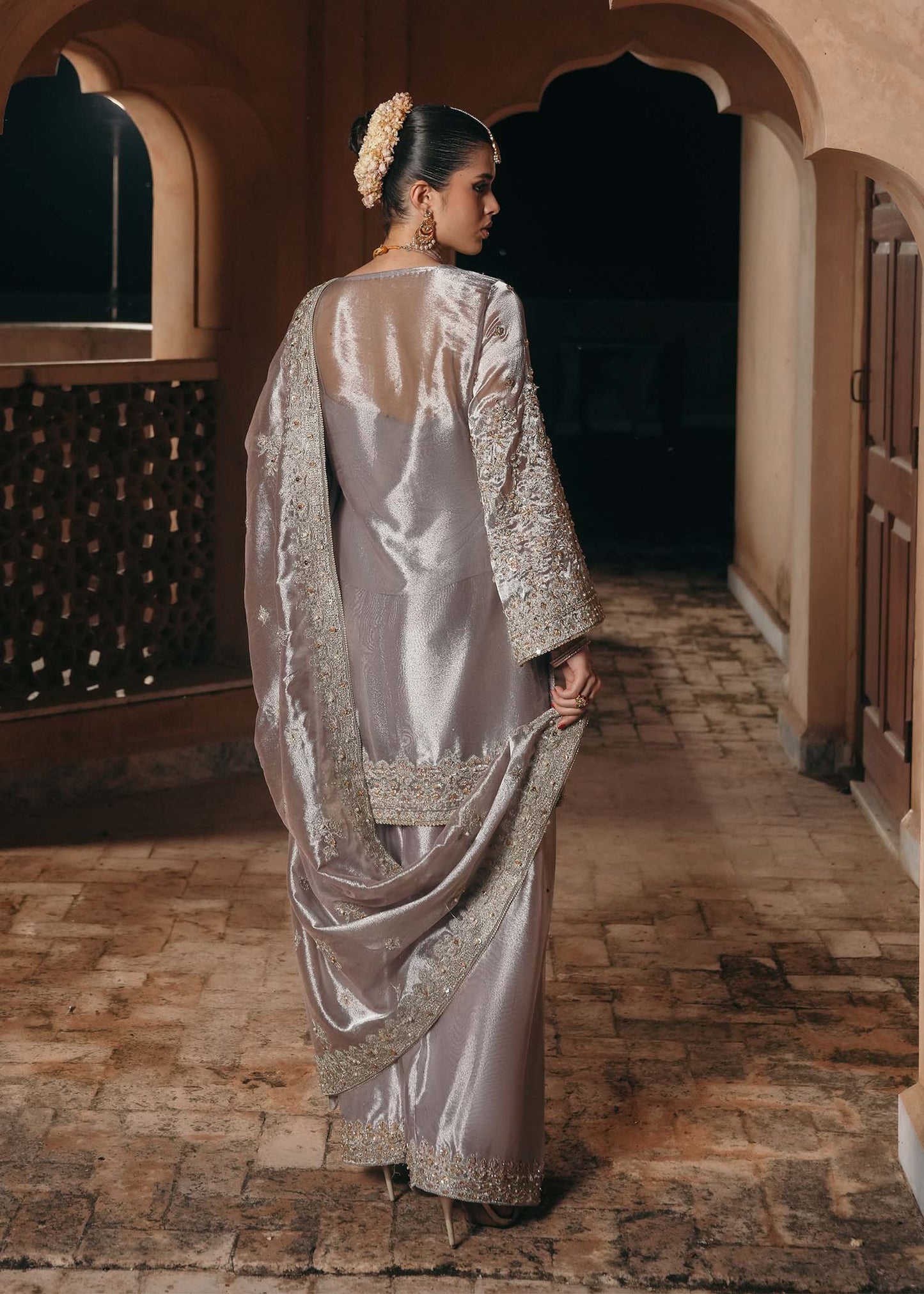Model wearing Gulnaar by Kanwal Malik in metallic silver with intricate embellishments – elegant Pakistani luxury pret outfit in UK.