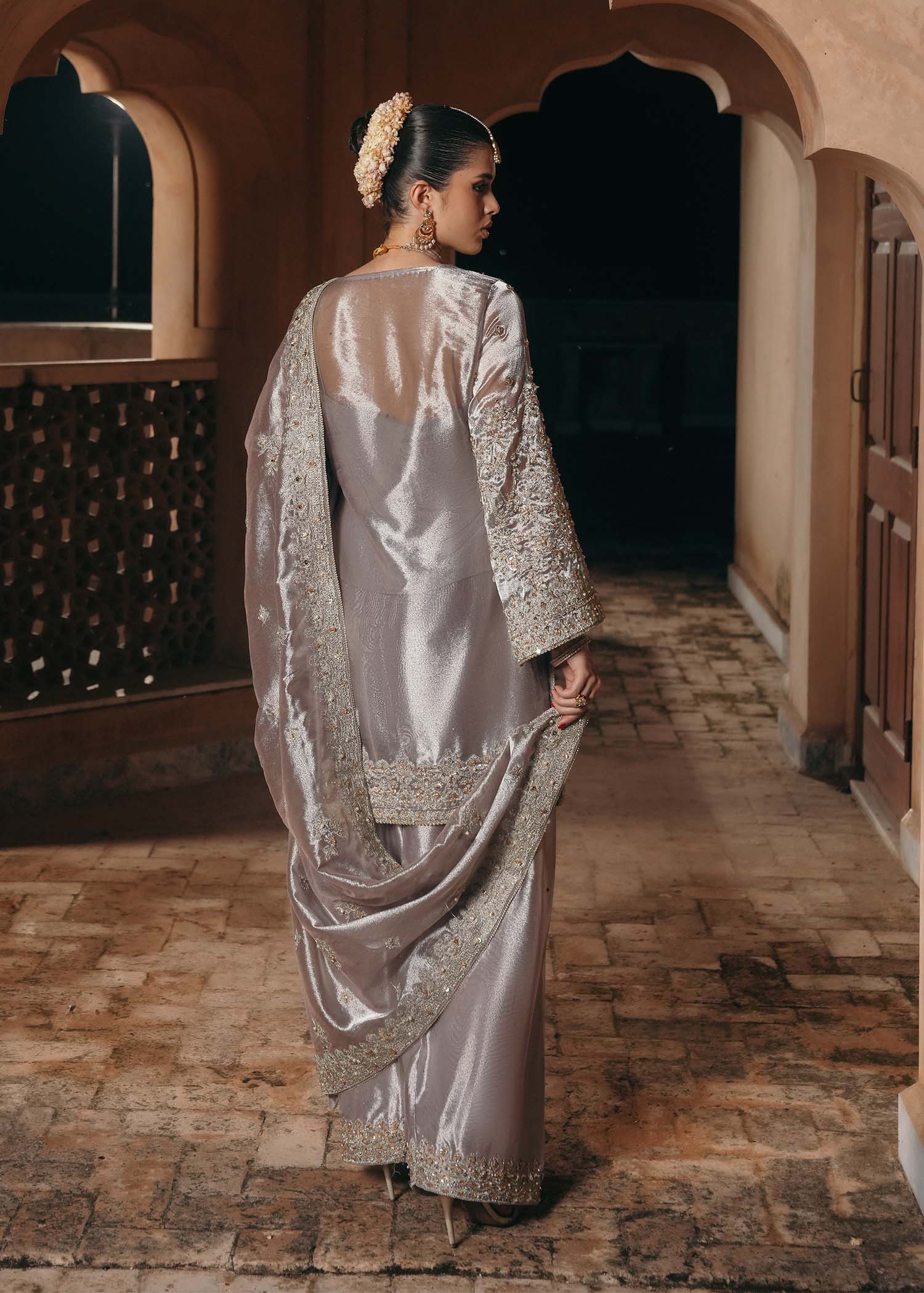 Model wearing Gulnaar by Kanwal Malik in metallic silver with intricate embellishments – elegant Pakistani luxury pret outfit in UK.
