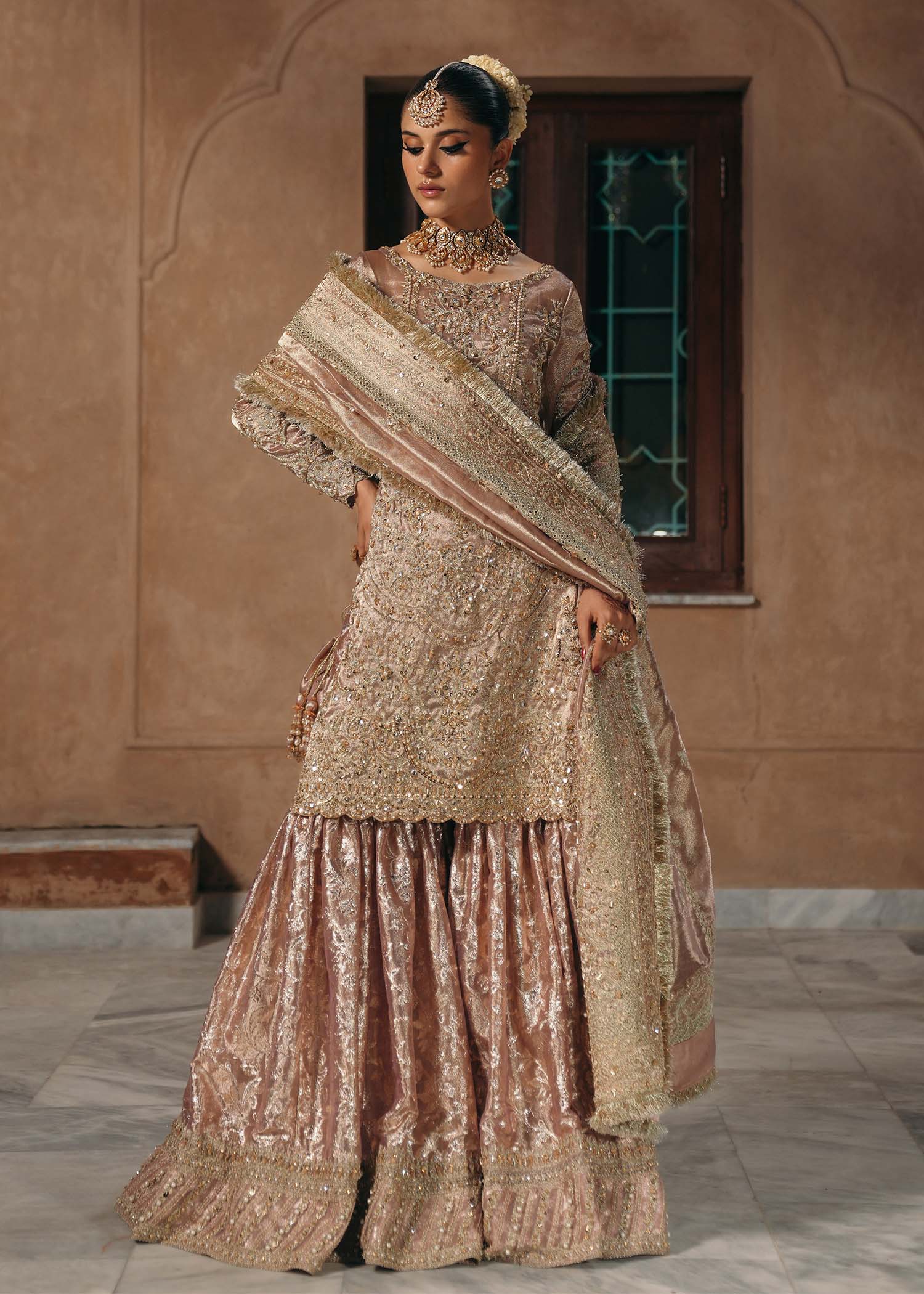 Model wearing Nazo by Kanwal Malik in dusty rose with gold embellishments – elegant Pakistani luxury pret for weddings in the UK.
