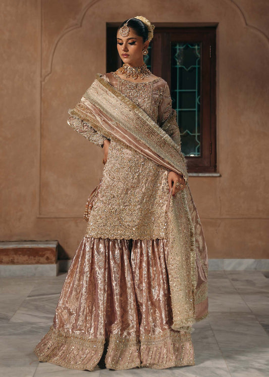 Model wearing Nazo by Kanwal Malik in dusty rose with gold embellishments – elegant Pakistani luxury pret for weddings in the UK.