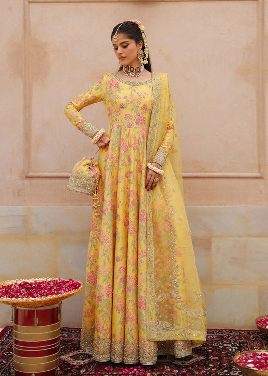 Model wearing Hoorain by Kanwal Malik in vibrant yellow with floral embroidery – festive Pakistani luxury pret outfit in UK.