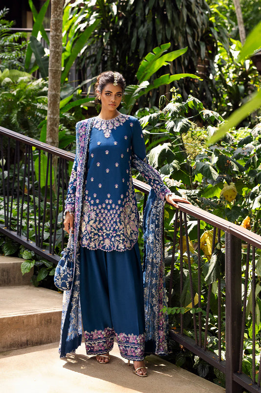 Model wearing Saira Rizwan DELARA-SRF25-08 in deep blue with floral embroidery – Pakistani luxury pret outfit, shop online in UK.
