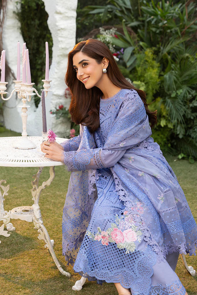 Model wearing Sobia Nazir Design 10B blue luxury lawn dress with intricate embroidery. Shop Pakistani clothes online in the UK for casual and festive wear.