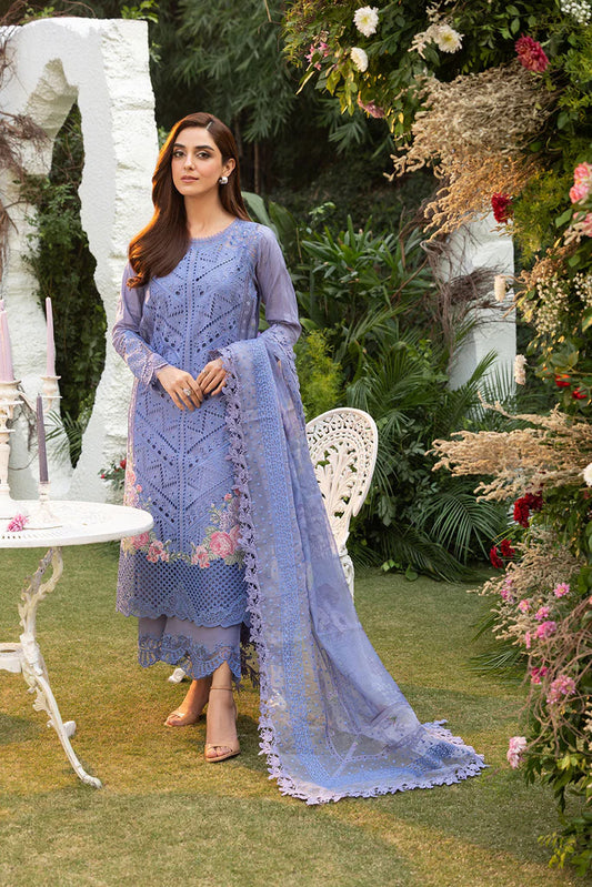 Model wearing Sobia Nazir Design 10B blue luxury lawn dress with intricate embroidery. Shop Pakistani clothes online in the UK for casual and festive wear.
