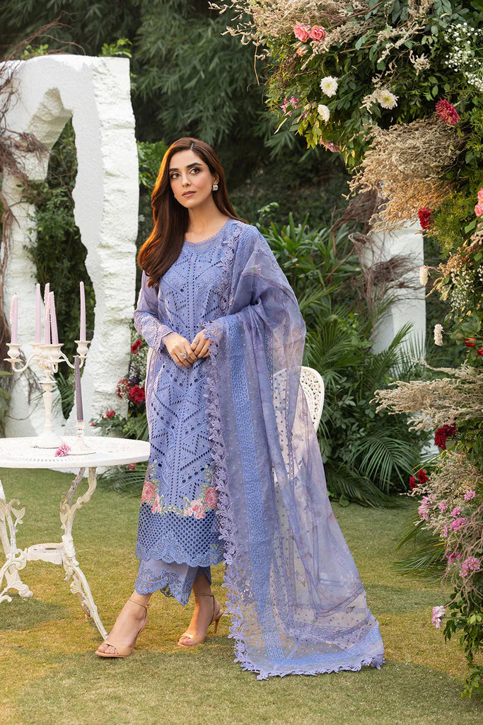 Model wearing Sobia Nazir Design 10B blue luxury lawn dress with intricate embroidery. Shop Pakistani clothes online in the UK for casual and festive wear.