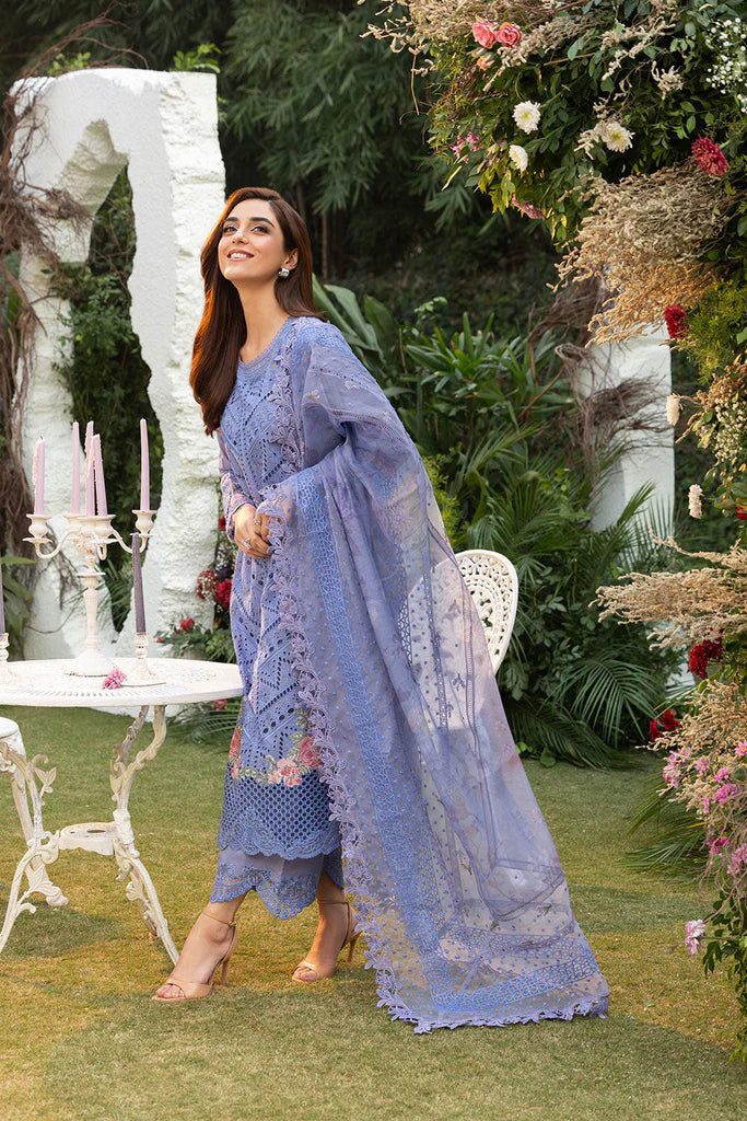 Model wearing Sobia Nazir Design 10B blue luxury lawn dress with intricate embroidery. Shop Pakistani clothes online in the UK for casual and festive wear.