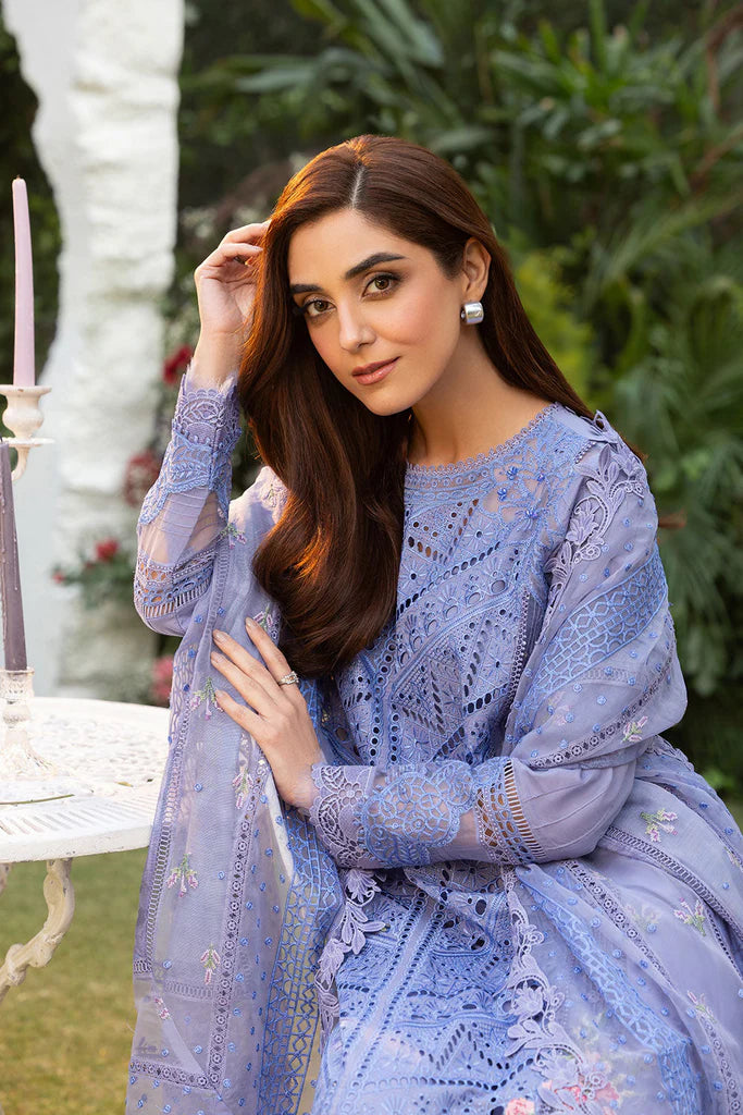 Model wearing Sobia Nazir Design 10B blue luxury lawn dress with intricate embroidery. Shop Pakistani clothes online in the UK for casual and festive wear.