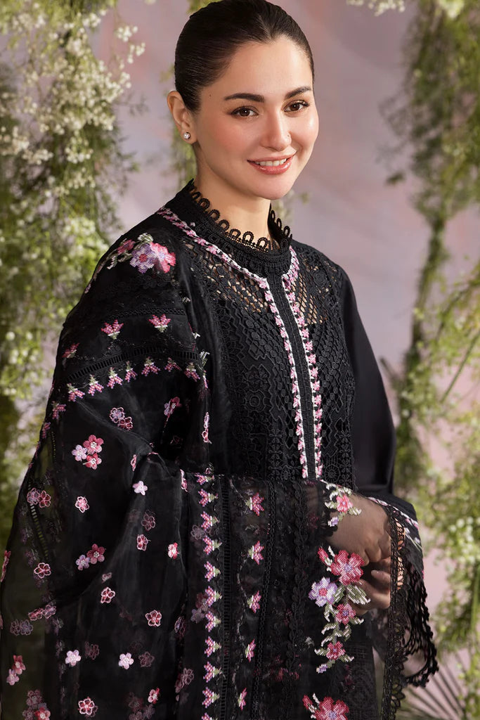 Model wearing Sobia Nazir Design 11A black luxury lawn dress with floral embroidery. Shop Pakistani clothes online in the UK for casual and festive wear.