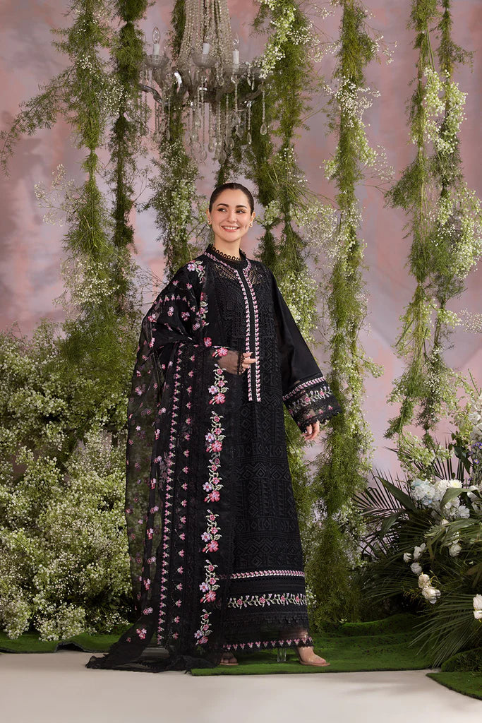 Model wearing Sobia Nazir Design 11A black luxury lawn dress with floral embroidery. Shop Pakistani clothes online in the UK for casual and festive wear.