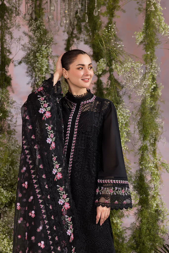 Model wearing Sobia Nazir Design 11A black luxury lawn dress with floral embroidery. Shop Pakistani clothes online in the UK for casual and festive wear.