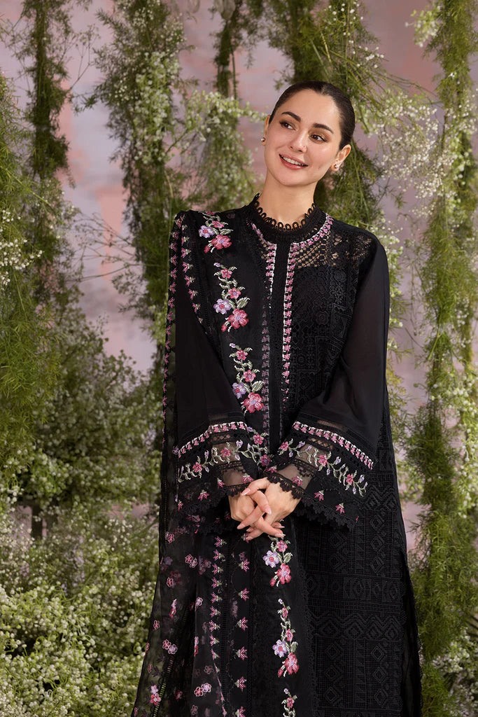 Model wearing Sobia Nazir Design 11A black luxury lawn dress with floral embroidery. Shop Pakistani clothes online in the UK for casual and festive wear.