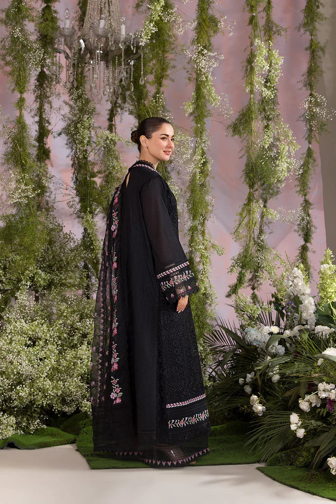 Model wearing Sobia Nazir Design 11A black luxury lawn dress with floral embroidery. Shop Pakistani clothes online in the UK for casual and festive wear.