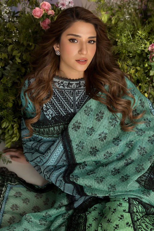 Model wearing Sobia Nazir Design 12A green luxury lawn dress with intricate embroidery. Shop Pakistani clothes online in the UK for casual and festive wear.