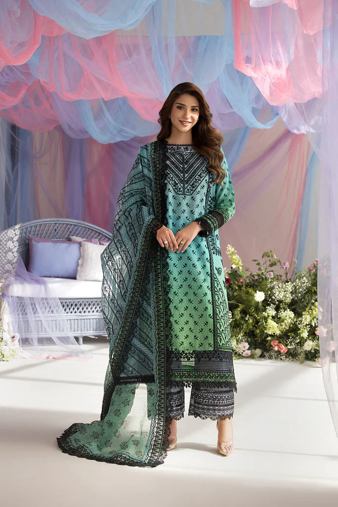 Model wearing Sobia Nazir Design 12A green luxury lawn dress with intricate embroidery. Shop Pakistani clothes online in the UK for casual and festive wear.