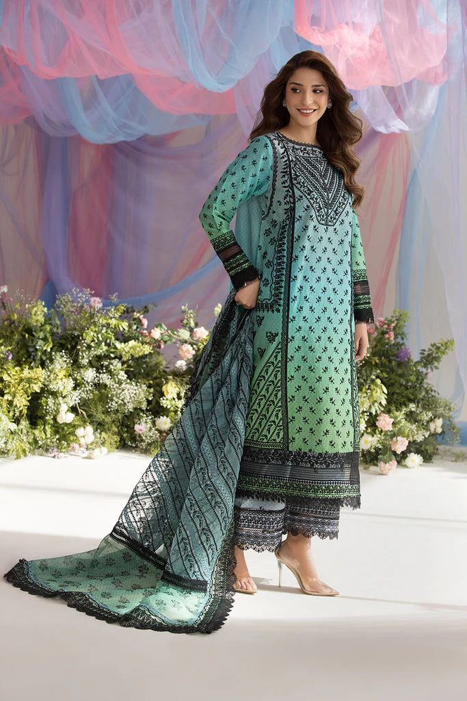 Model wearing Sobia Nazir Design 12A green luxury lawn dress with intricate embroidery. Shop Pakistani clothes online in the UK for casual and festive wear.