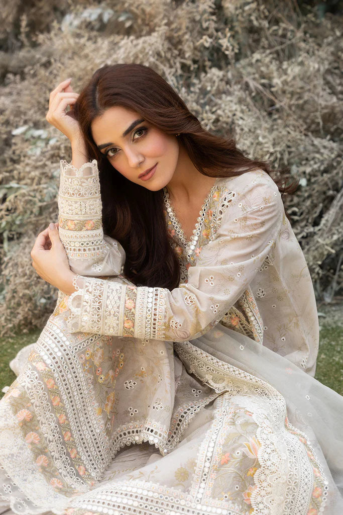 Model wearing Sobia Nazir Design 13B ivory luxury lawn dress with intricate embroidery. Shop Pakistani clothes online in the UK for casual and festive wear.