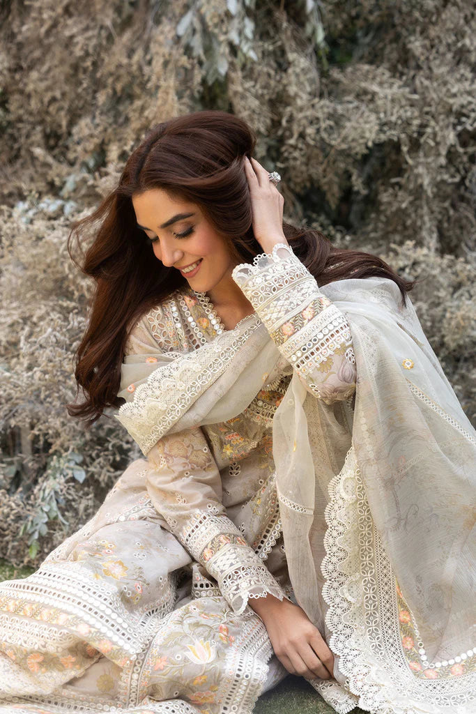 Model wearing Sobia Nazir Design 13B ivory luxury lawn dress with intricate embroidery. Shop Pakistani clothes online in the UK for casual and festive wear.