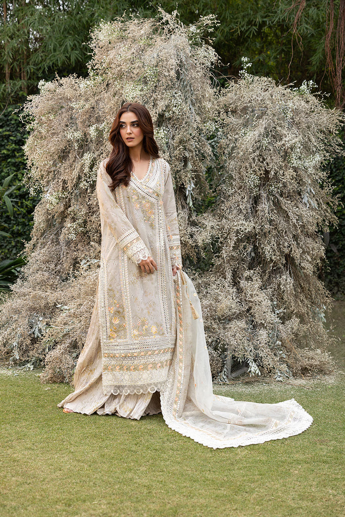 Model wearing Sobia Nazir Design 13B ivory luxury lawn dress with intricate embroidery. Shop Pakistani clothes online in the UK for casual and festive wear.