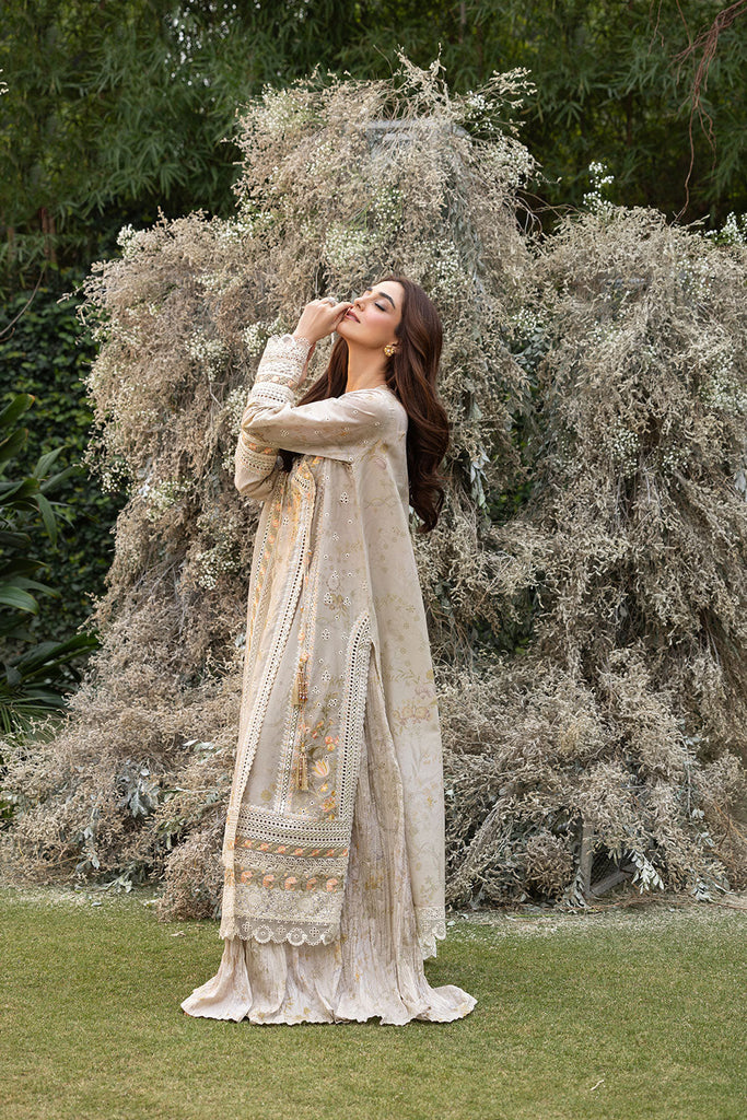 Model wearing Sobia Nazir Design 13B ivory luxury lawn dress with intricate embroidery. Shop Pakistani clothes online in the UK for casual and festive wear.