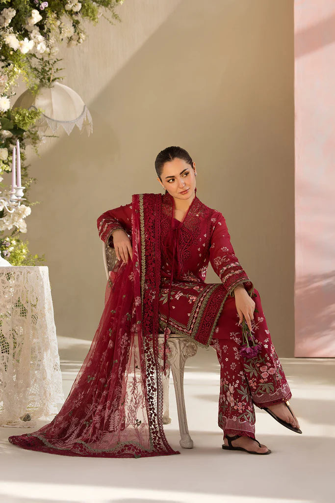 Model wearing Sobia Nazir Design 14A deep red luxury lawn dress with floral embroidery. Shop Pakistani clothes online in the UK for casual and festive wear.