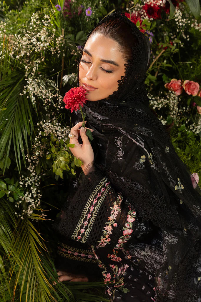 Model wearing Sobia Nazir Design 14B black luxury lawn dress with floral embroidery. Shop Pakistani clothes online in the UK for casual and festive wear.
