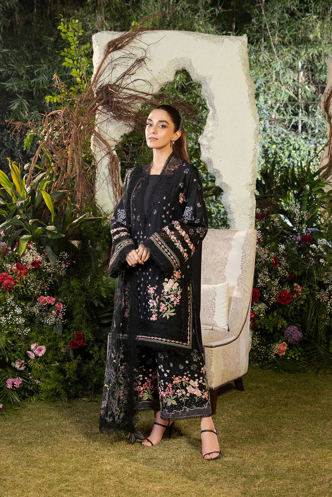 Model wearing Sobia Nazir Design 14B black luxury lawn dress with floral embroidery. Shop Pakistani clothes online in the UK for casual and festive wear.
