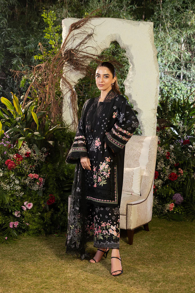 Model wearing Sobia Nazir Design 14B black luxury lawn dress with floral embroidery. Shop Pakistani clothes online in the UK for casual and festive wear.
