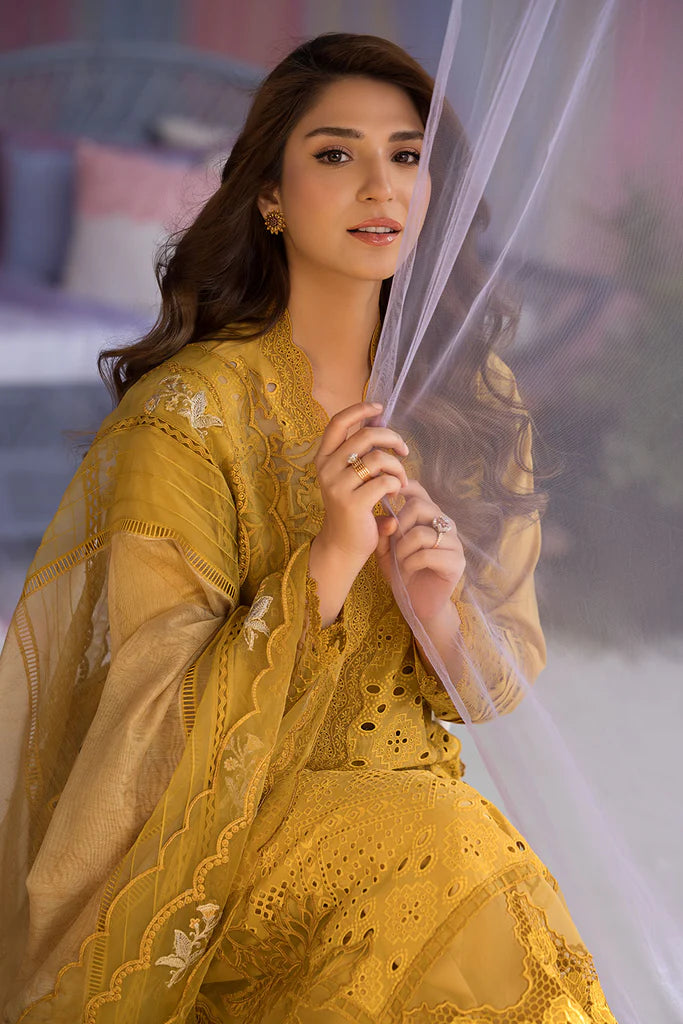 Model wearing Sobia Nazir Design 1A mustard yellow luxury lawn dress with intricate embroidery. Shop Pakistani clothes online in the UK for casual and festive wear.