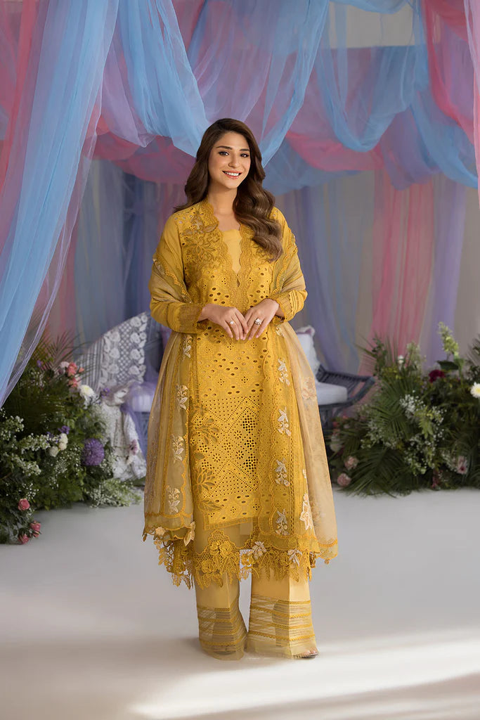 Model wearing Sobia Nazir Design 1A mustard yellow luxury lawn dress with intricate embroidery. Shop Pakistani clothes online in the UK for casual and festive wear.