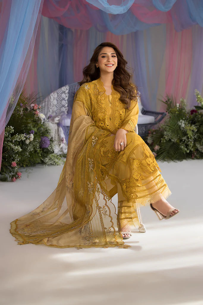 Model wearing Sobia Nazir Design 1A mustard yellow luxury lawn dress with intricate embroidery. Shop Pakistani clothes online in the UK for casual and festive wear.