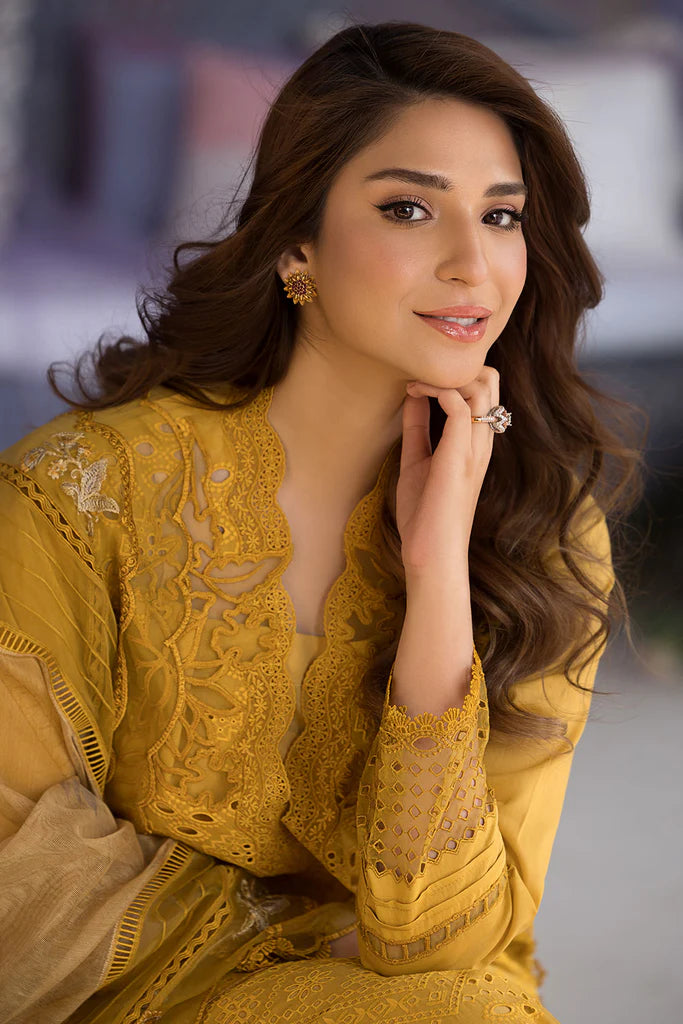 Model wearing Sobia Nazir Design 1A mustard yellow luxury lawn dress with intricate embroidery. Shop Pakistani clothes online in the UK for casual and festive wear.