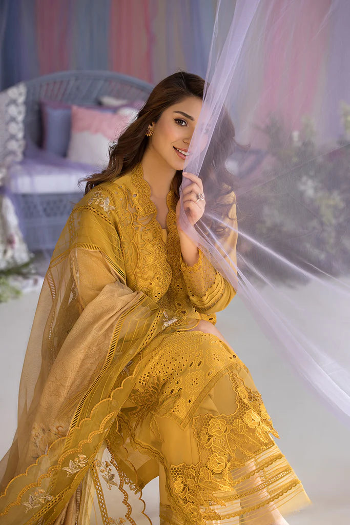 Model wearing Sobia Nazir Design 1A mustard yellow luxury lawn dress with intricate embroidery. Shop Pakistani clothes online in the UK for casual and festive wear.