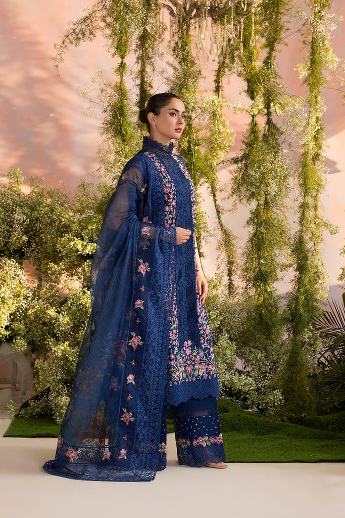 Model wearing Sobia Nazir Design 4A navy blue luxury lawn dress with floral embroidery. Shop Pakistani clothes online in the UK for casual and festive wear.