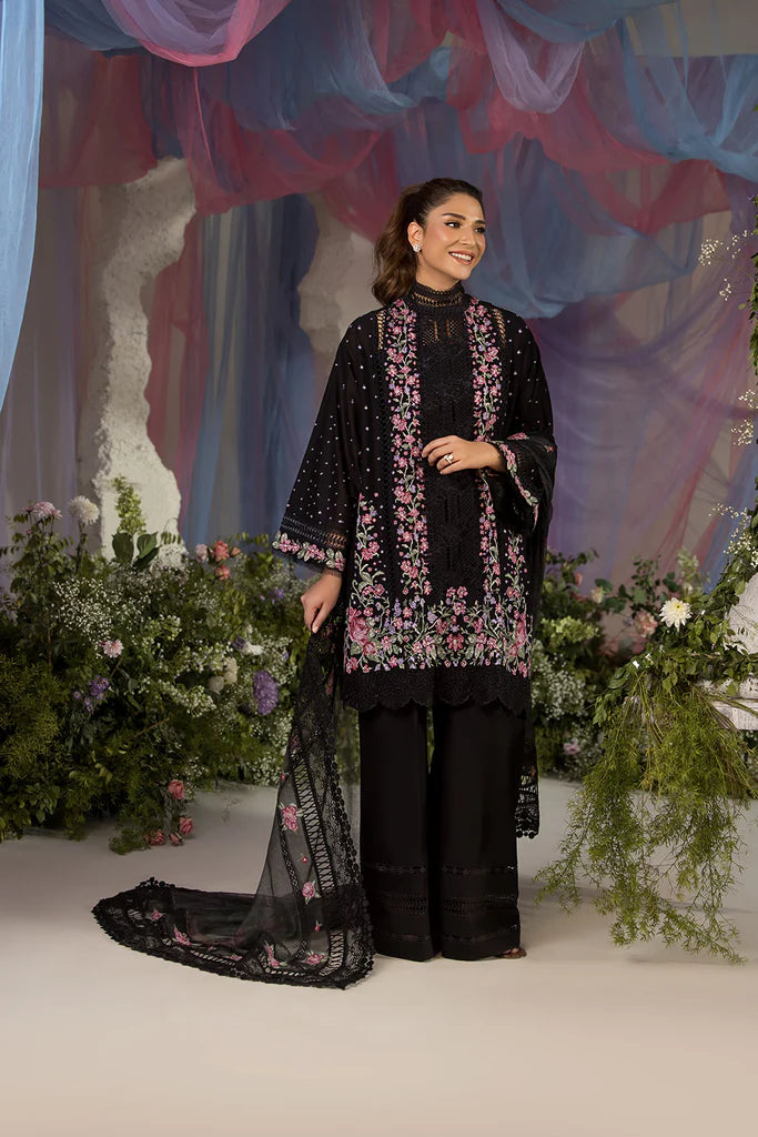 Model wearing Sobia Nazir Design 4B black luxury lawn dress with floral embroidery. Shop Pakistani clothes online in the UK for casual and festive wear.