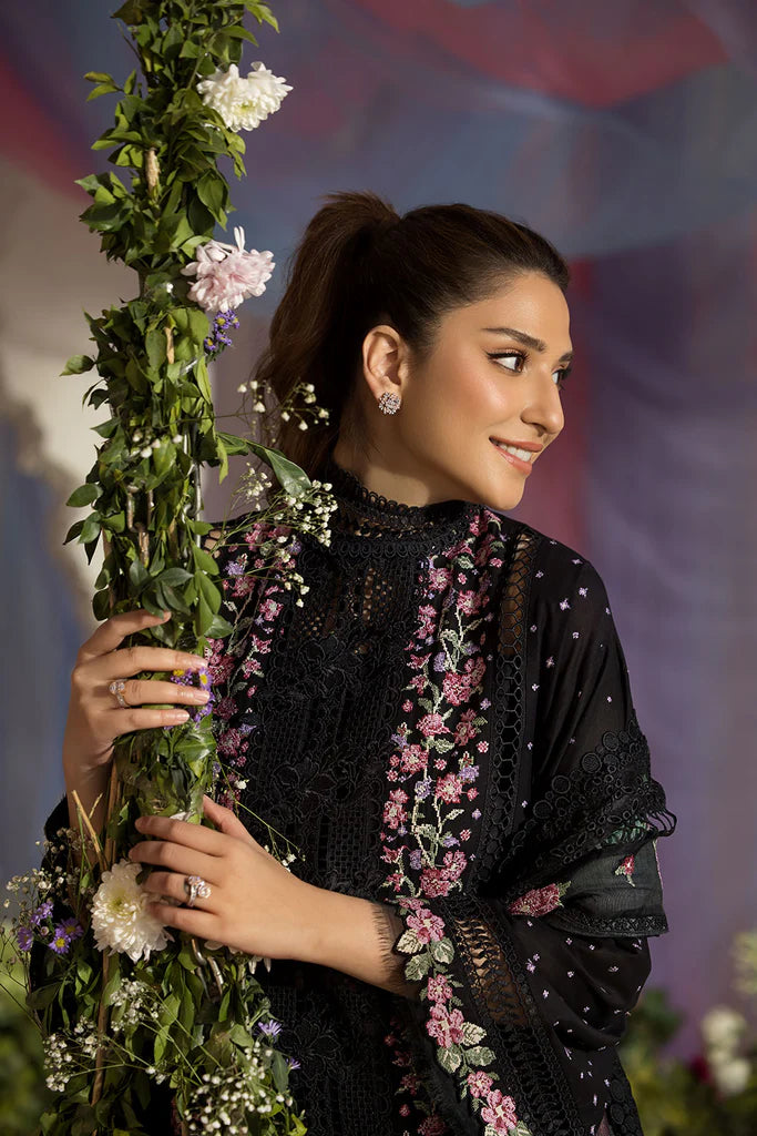 Model wearing Sobia Nazir Design 4B black luxury lawn dress with floral embroidery. Shop Pakistani clothes online in the UK for casual and festive wear.